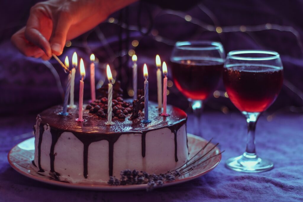 Preparing for a birthday celebration, lighting candles on a birthday cake